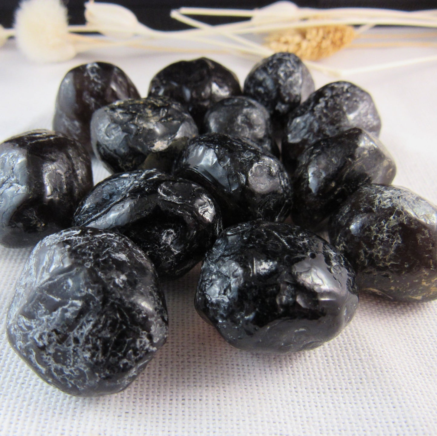 Black stones on a white fabric background